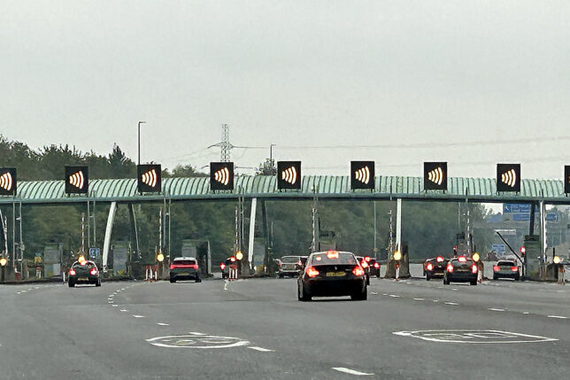 cars on a road with a bridge and a bridge