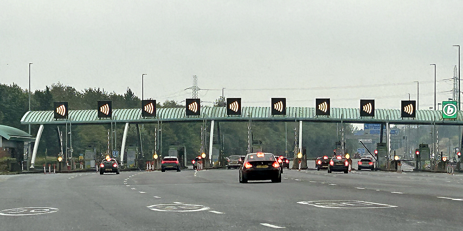 cars on a road with a bridge and a bridge