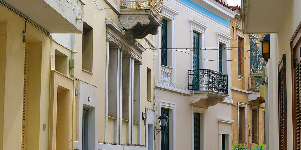 a person walking down a street with buildings
