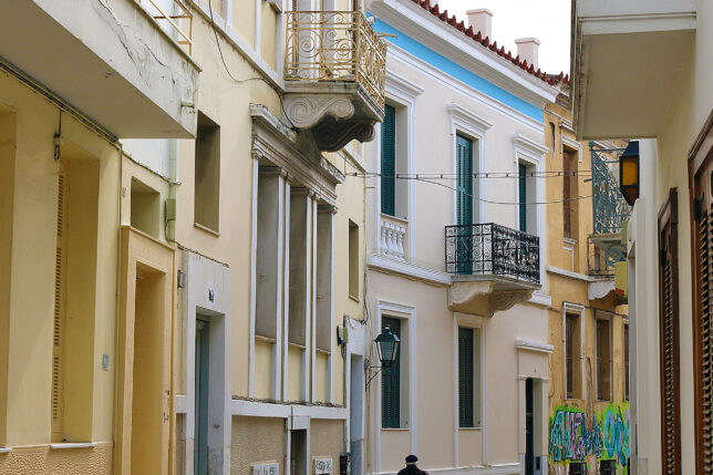 a person walking down a street with buildings