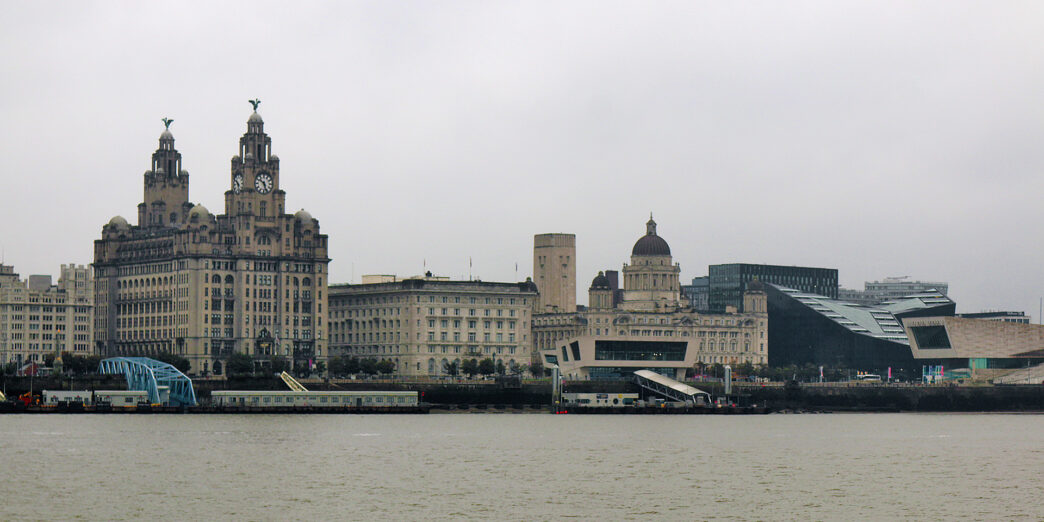 a city skyline with a train on the water