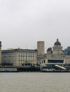 a city skyline with a train on the water