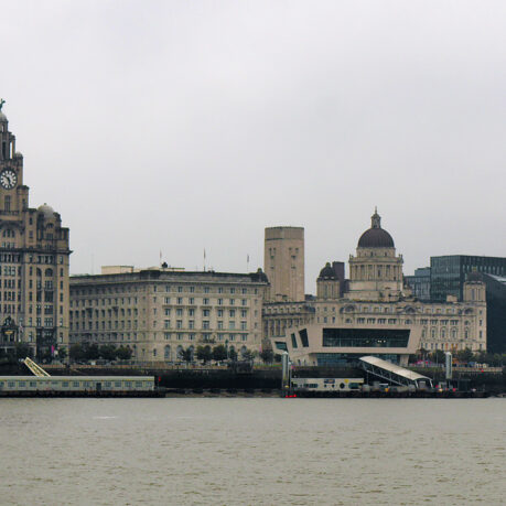 a city skyline with a train on the water