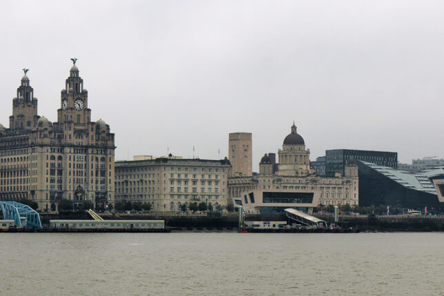 a city skyline with a train on the water