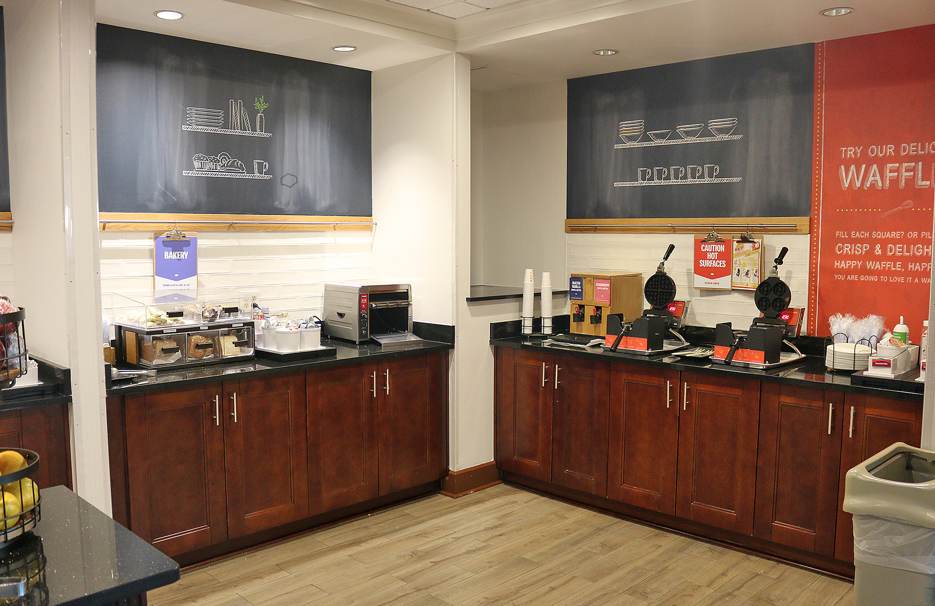 a coffee shop with wood cabinets and black counter tops