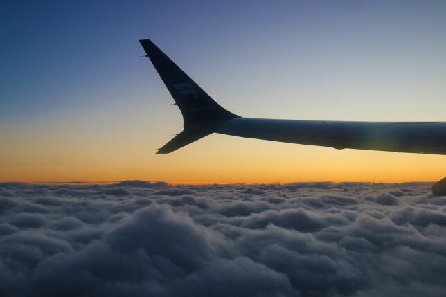 the wing of an airplane above clouds