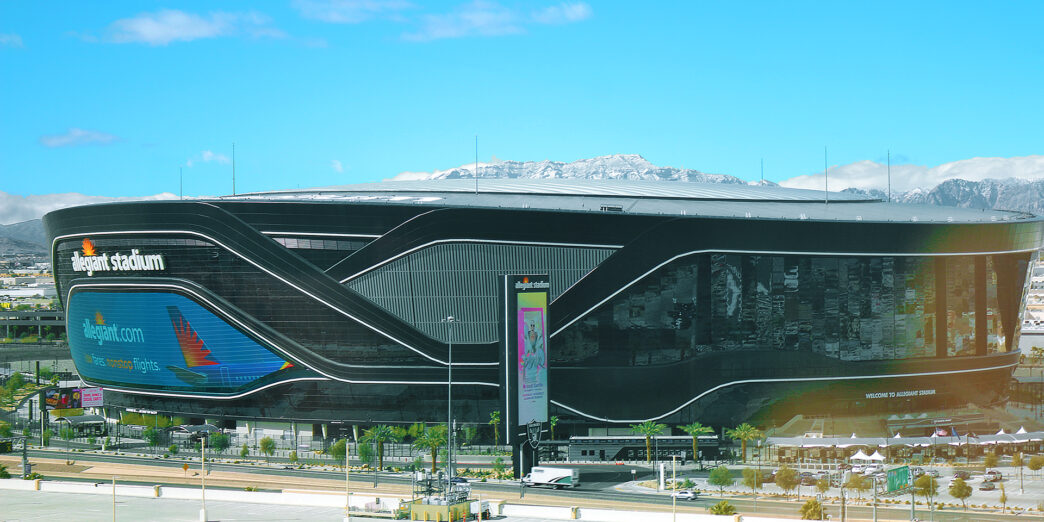 a large building with a lot of cars and a parking lot