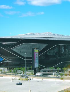 a large building with a lot of cars and a parking lot