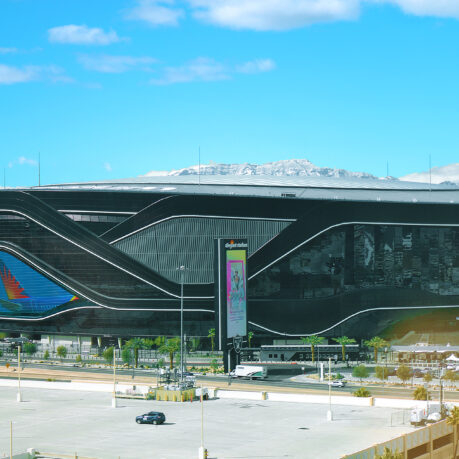 a large building with a lot of cars and a parking lot