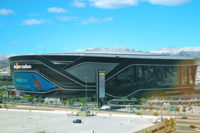 a large building with a lot of cars and a parking lot