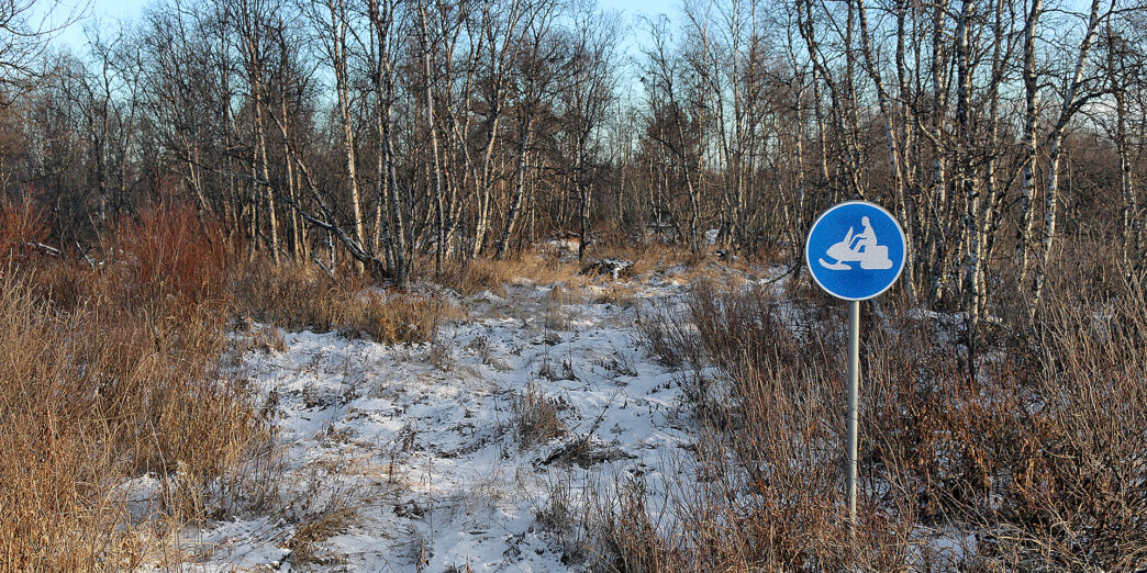 a sign in a snowy field