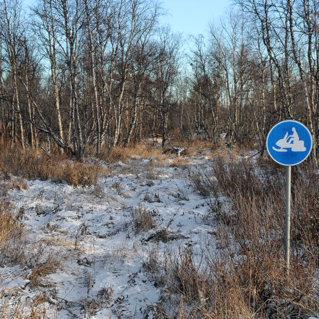 a sign in a snowy field
