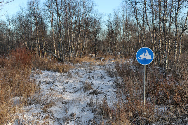 a sign in a snowy field