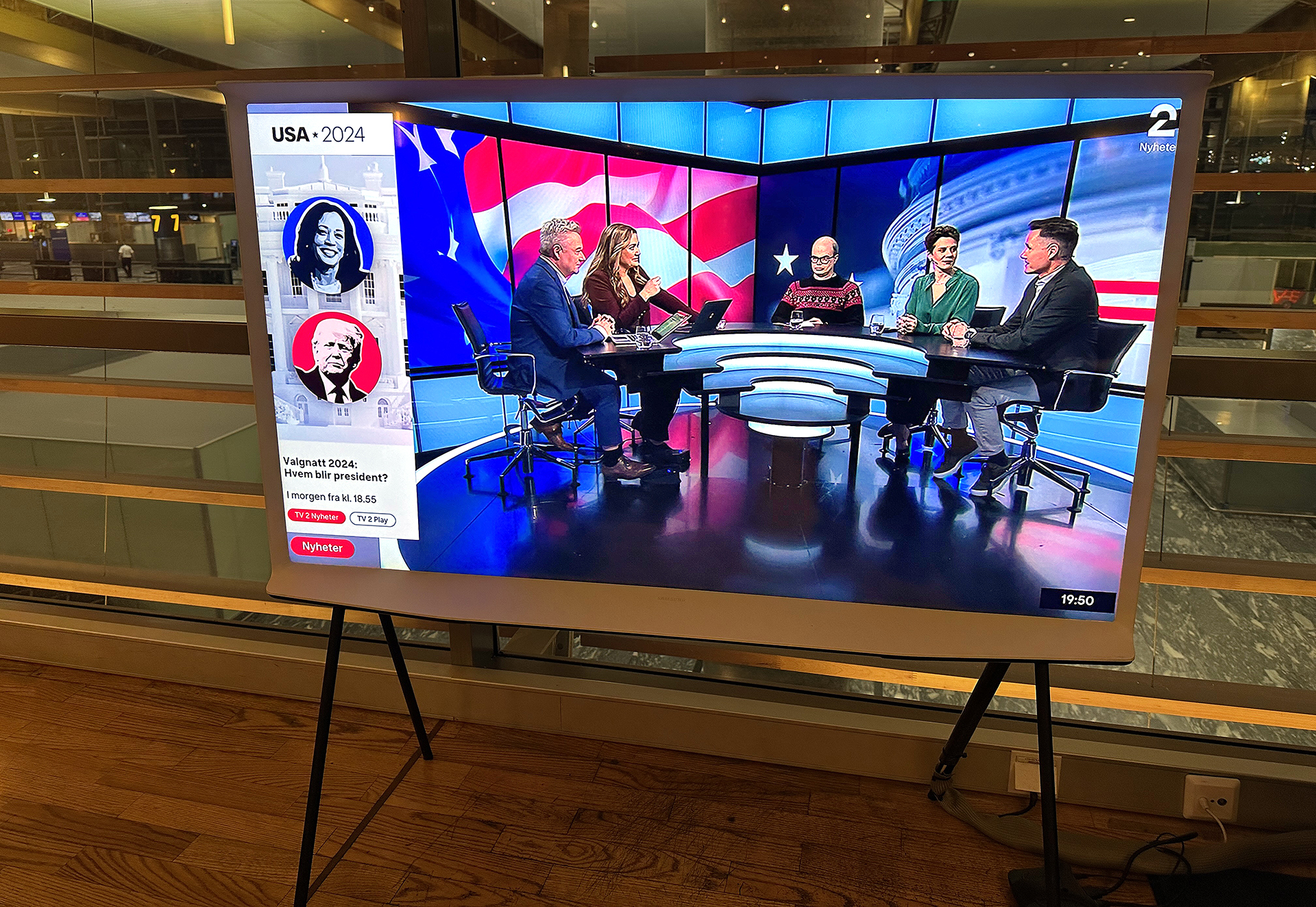 a television screen with people sitting at a table