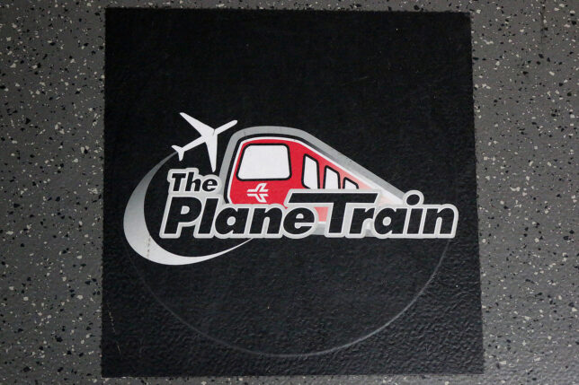 a black square with a red and white logo on it