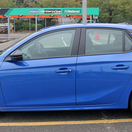 a blue car parked in a parking lot