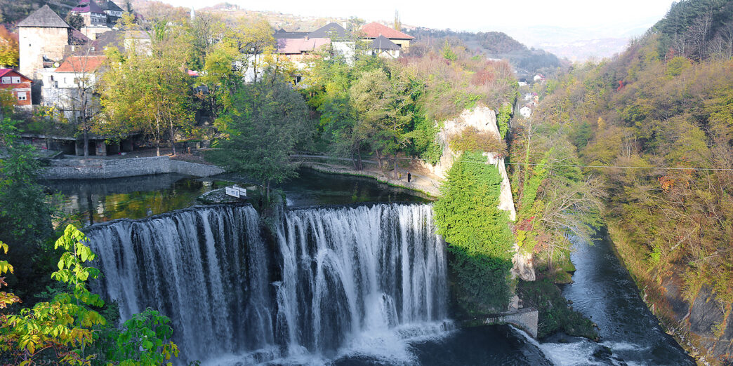 a waterfall surrounded by trees