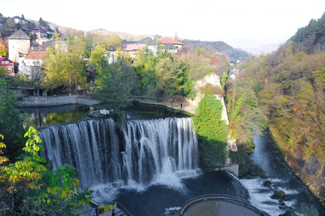 a waterfall surrounded by trees