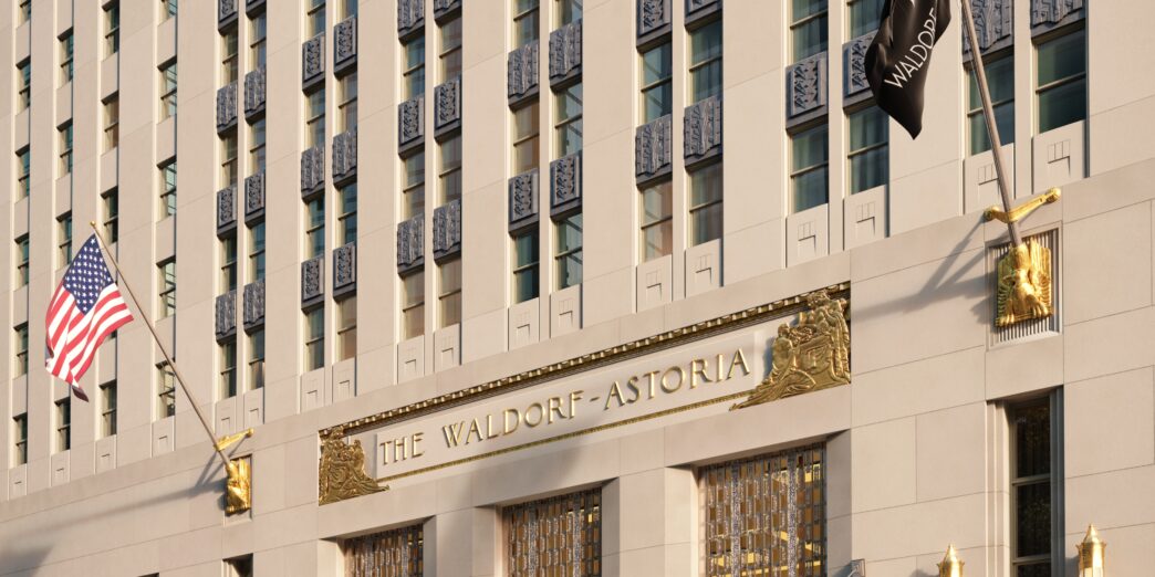 a building with flags and cars