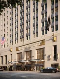 a building with flags and cars