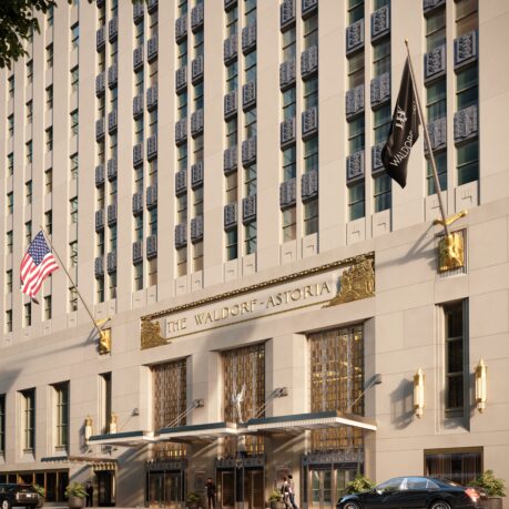 a building with flags and cars