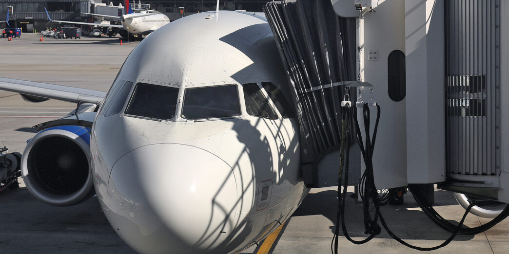 a white airplane at an airport