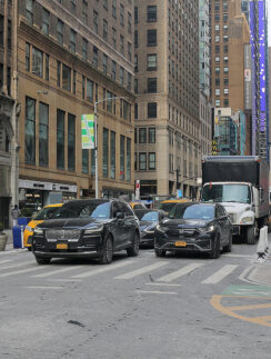 cars parked cars on a street in a city