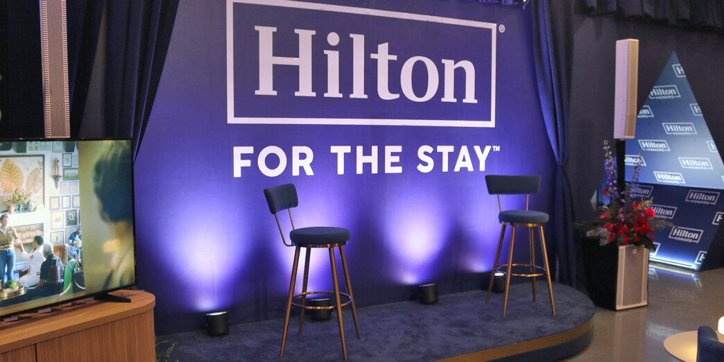 a blue stage with chairs and a blue curtain