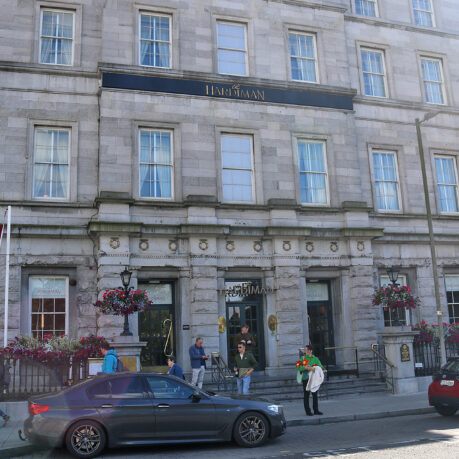 a building with people walking in front of it