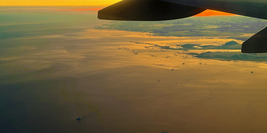 an airplane wing above the water