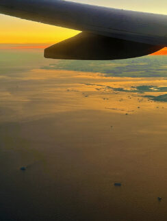 an airplane wing above the water