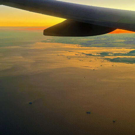 an airplane wing above the water