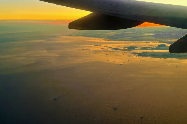 an airplane wing above the water