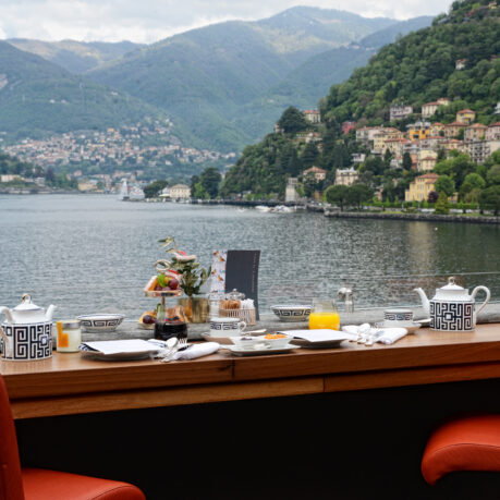 a table with a view of a lake and mountains in the background