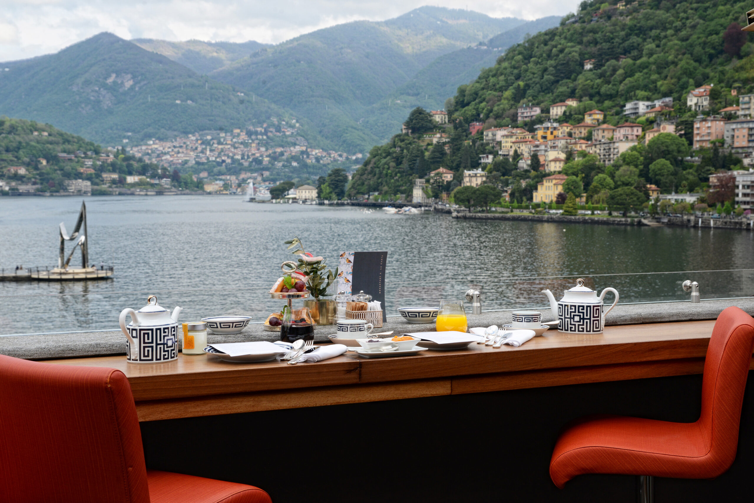 a table with a view of a lake and mountains in the background