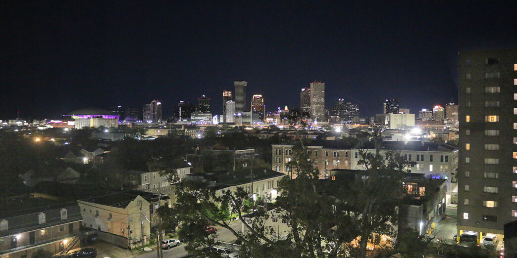 a city at night with trees and buildings
