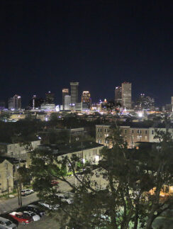 a city at night with trees and buildings