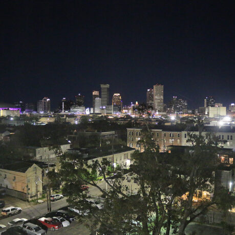 a city at night with trees and buildings