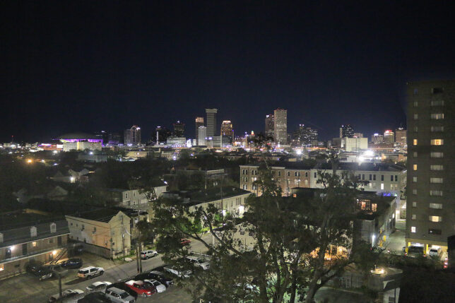 a city at night with trees and buildings