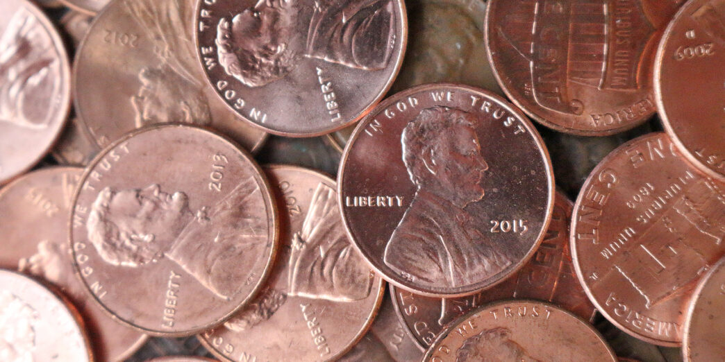 a pile of coins with a picture of a man