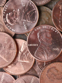 a pile of coins with a picture of a man