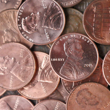 a pile of coins with a picture of a man