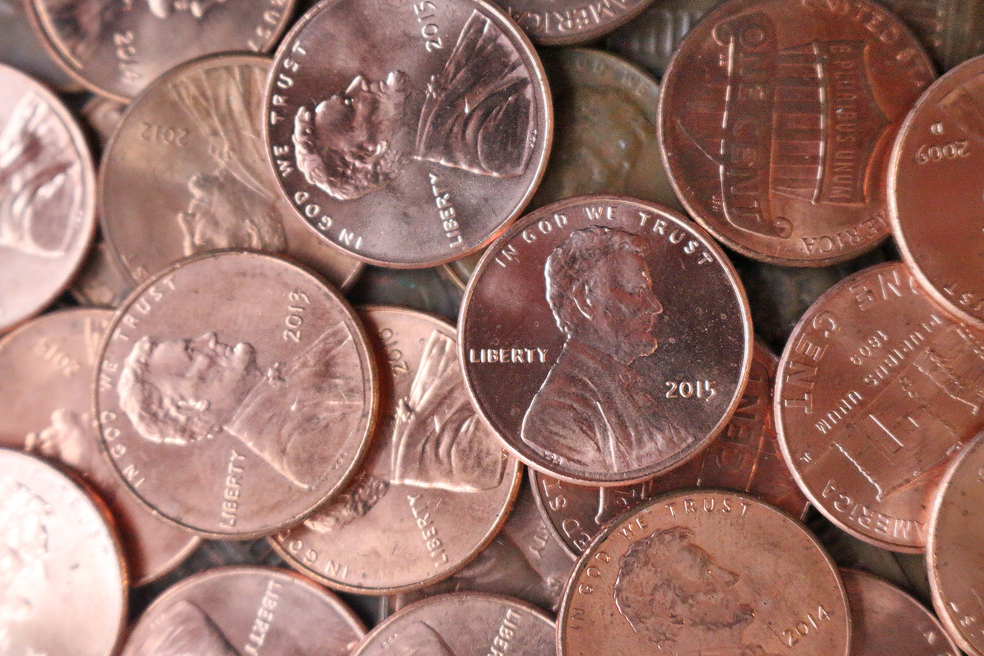 a pile of coins with a picture of a man