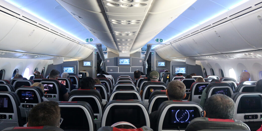 a group of people sitting in an airplane