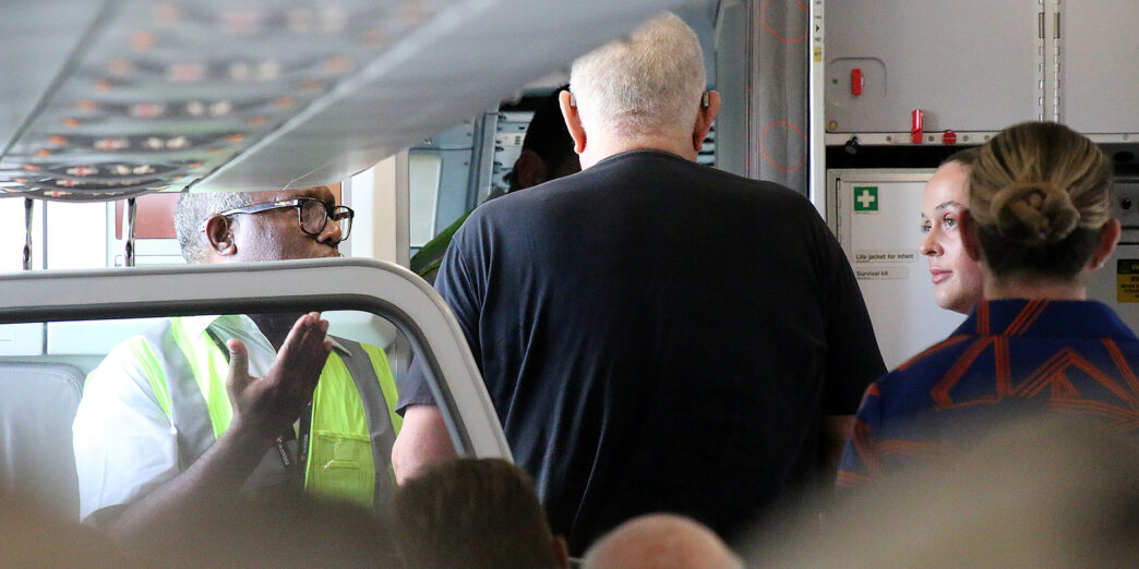 a man standing in a room with a door open