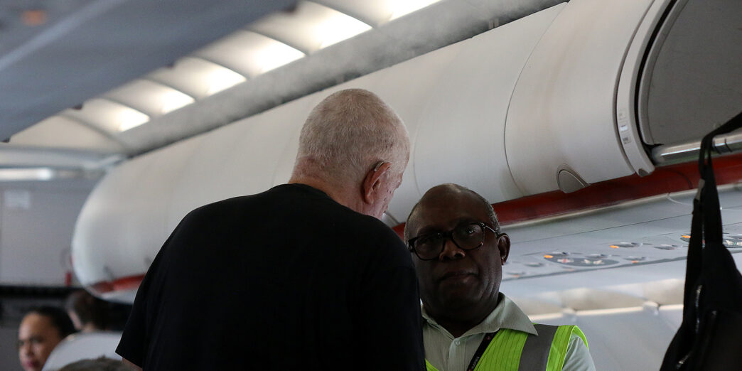 a man standing next to another man