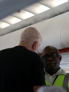 a man standing next to another man