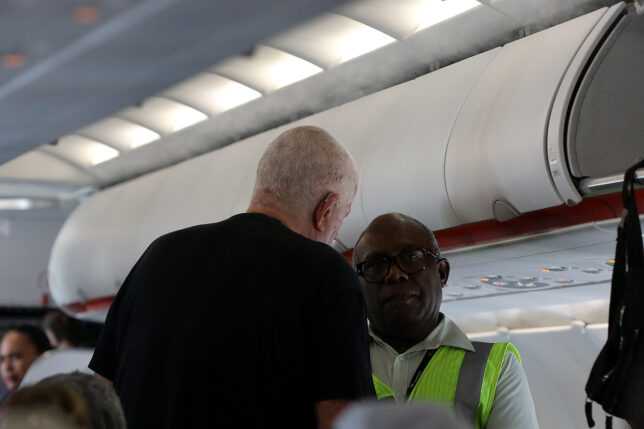 a man standing next to another man