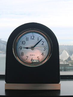 a clock on a window sill