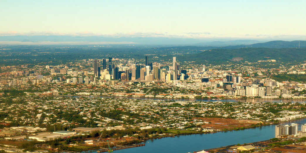 a city with a river and a city in the distance